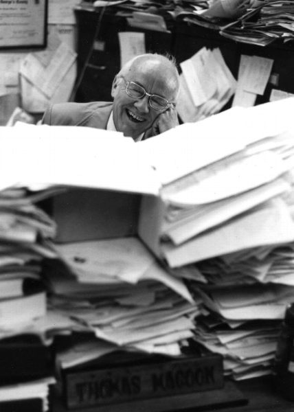 Jovial Magoon surrounded by files